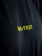 Close-up of a black WE•TRST t-shirt with a focus on the soft fabric, relaxed fit, and short sleeves.